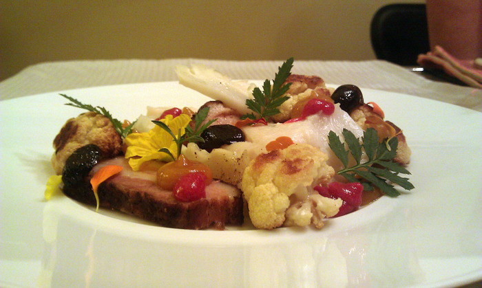 Poached black cod with local pork belly, roasted cauliflower and cranberry gastrique.