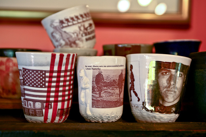 Ehren's ceramic cups with images from war stories.