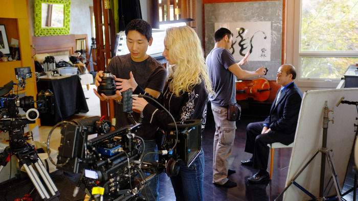 First AC Justin Jeung, Camera Assistant Cara Briese and Director of Photography David Y. Chung prepare cameras for an interview with PACO's Board Chairman Cary Chin.