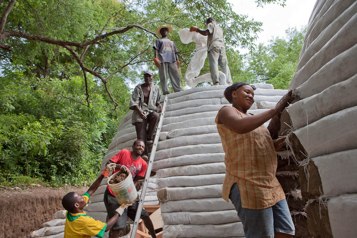 Community center under construction: This style of architecture requires no scaffolding or heavy machinery to build, and can be learned by everyone on the community.