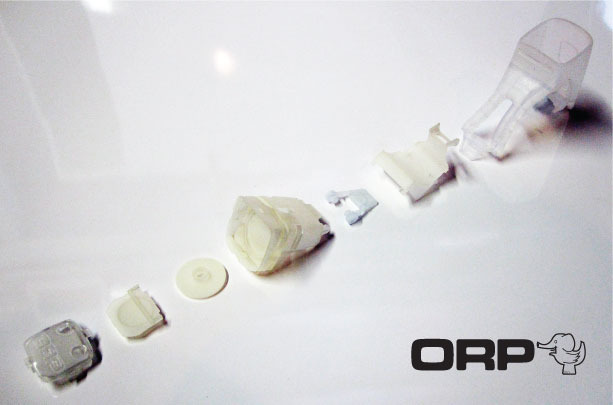 These are rapid prototypes of all the molded ready-for-production parts. Production parts for the hard plastics will be polycarbonate. The skin wilth its integral tail/ strap is silicone.
