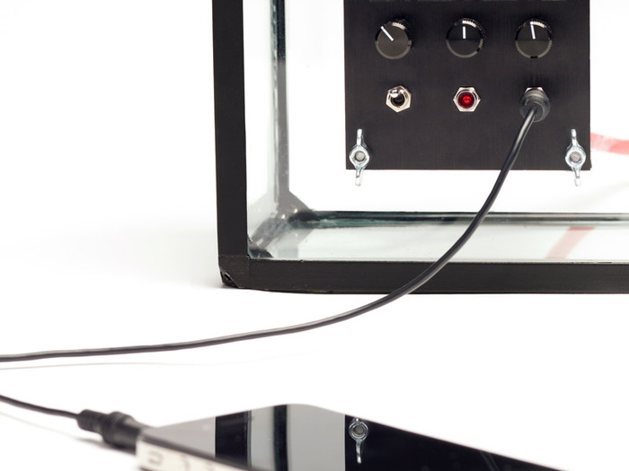 You can plug in with the 3.5mm auxiliary cable (head phone size cable) included with the speaker. Iphone NOT included.