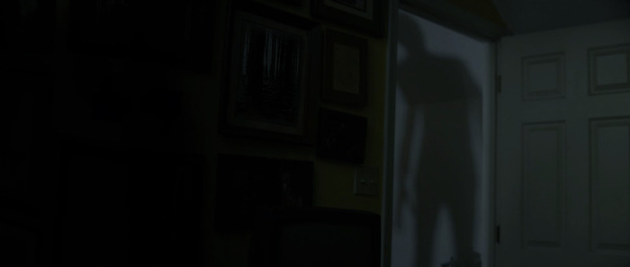 The Entity lurks outside the door.