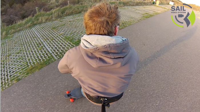 Testing the camera mount on a longboard.