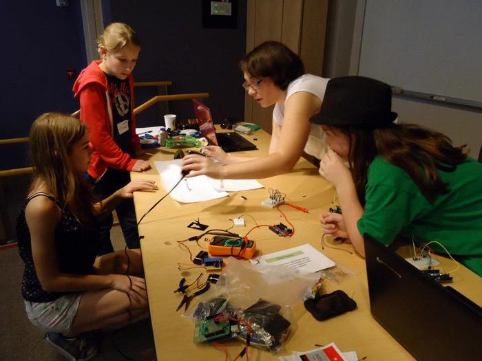 The team soldering their hardware. Sarah -- ThoughtSTEM Co-Founder -- explains how it's done.