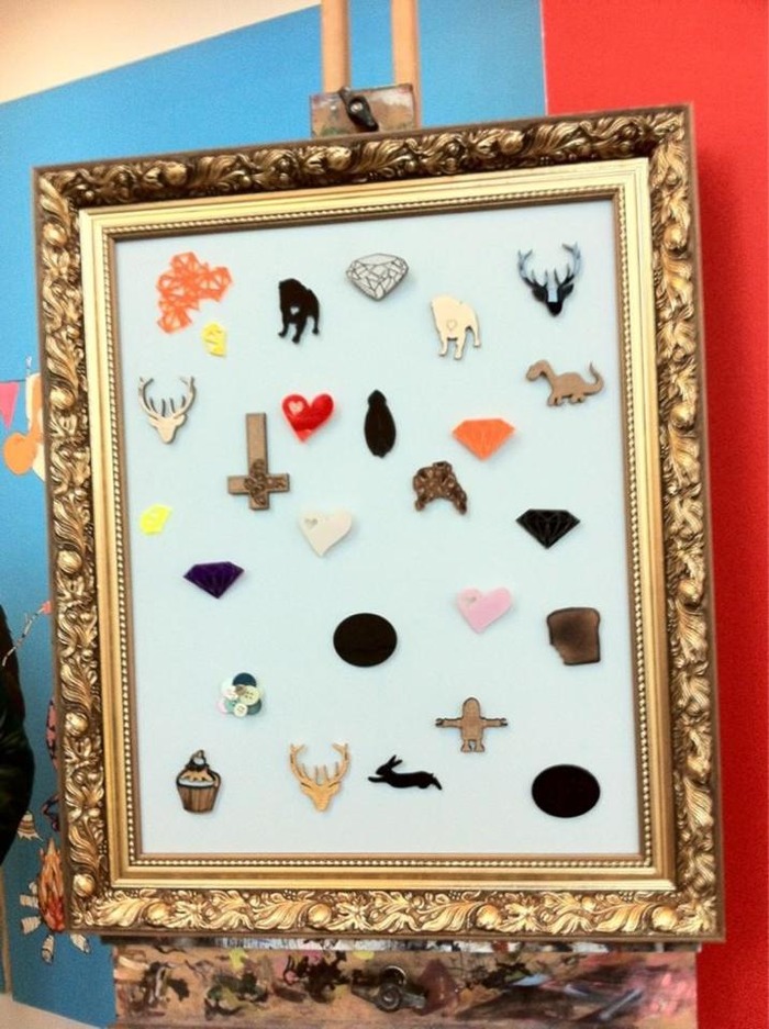 Mixture of wood and acrylic badges made by the class designers. There are crazy robots, adorable dinosaurs, dazzling diamonds, dainty deer, bouncy rabbits, abstract shapes, cutey pugs, delicious cupcakes, crawly beetles and lovely love-hearts.