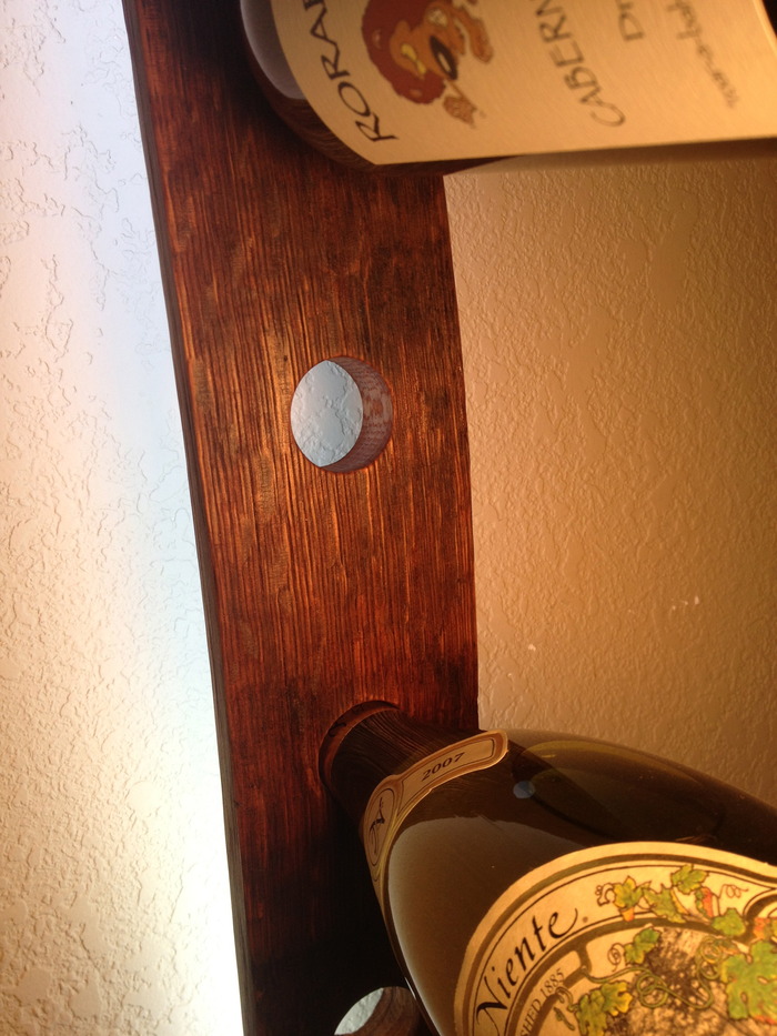 Angle specific holes are cut to rest the bottleneck.