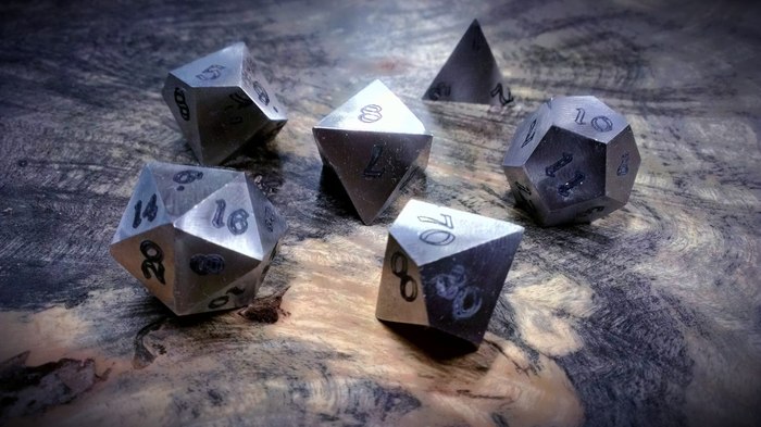 Prototype Stainless Steel Dice. All metal dice will use this font.