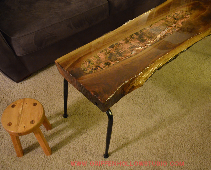 This is a piece in my personal collection. Live edge walnut with a hard epoxy finish. The legs are made from old school chairs. The center is a piece of copper from an old roof top.