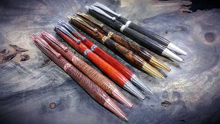 From left to right: Macadamia Nut w/ Copper Hardware, Bloodwood w/ Chrome Hardware, Desert Ironwood Burl w/ Gold Hardware, and Blue Mahoe w/ Satin Chrome Hardware.