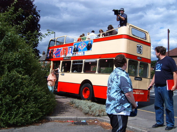 Director Steve Sullivan filming on top of the bus during the Magical Timperley Tour