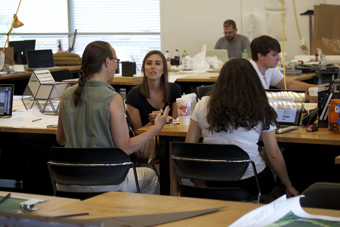 Students at work with professors in studio