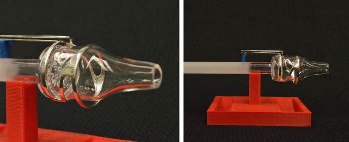 The quartz plasma chamber surrounded by a solid silver RF antenna. The propellant enters from the left, is ionized into a plasma in the bottle shaped region, and accelerated out of the nozzle to the right to produce thrust, pushing the CubeSat to the left