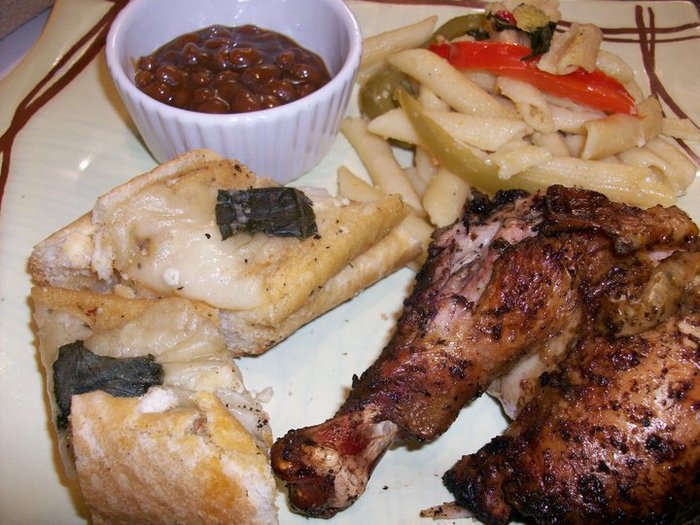 Jerk chicken prepared using the Jamaican Jerk Rub with Lemon Butter infused Penne Pasta with basil, Tri colored peppers, lemon juice, lemon zest and Parmesan cheese; Sweet Bourbon Baked Beans; Garlic Bread topped with garlic butter, mozz cheese and basil.