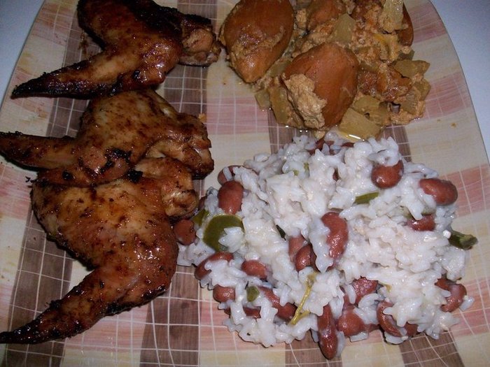 Jerk Chicken wings prepared using the Jamaican Jerk Rub. On the side Sweet Potatoes and Pineapple casserole; Rice and Red Beans flavored with coconut milk and jalapeno.