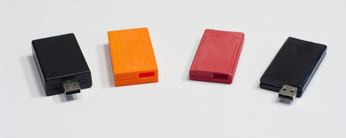Two of our working prototypes along with some of the different enclosure designs we've looked at during the development process.