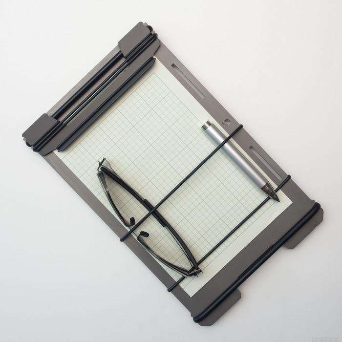 SMALL BANDBOARD WITH PEN AND SUNGLASSES.