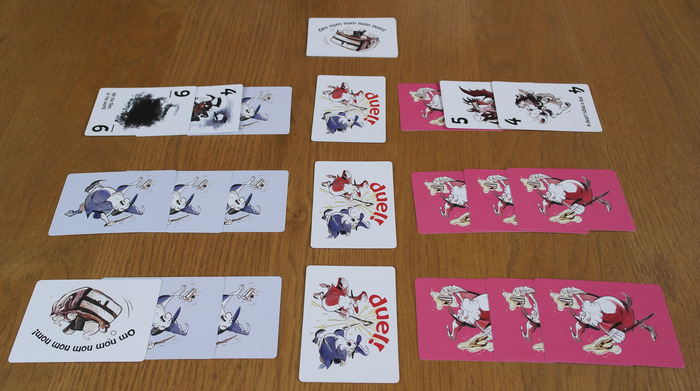 All cards have been played, so we join as a round is being resolved. Blue Wizard has won the first round so is playing with one cake card in place of a spell.