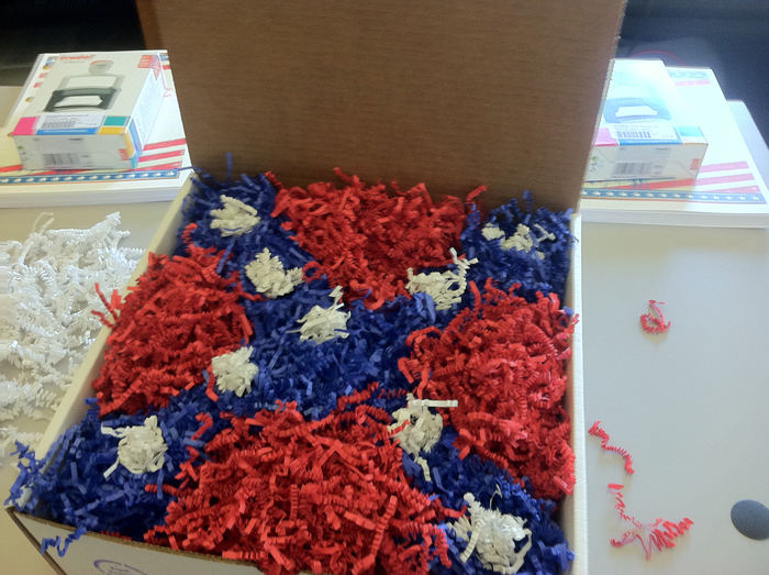 Step 6. The reply and the rubber stamp are enclosed in a white box, and then red, blue, and white crinkle-pak is used to create an image of the Mississippi flag.