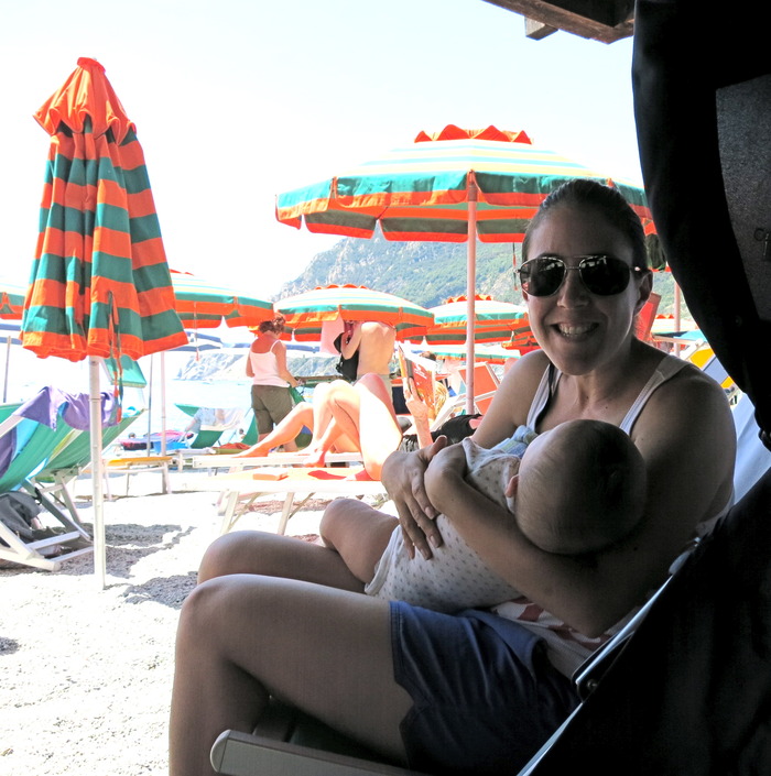 Moon Mama founder, Gemma, forcing a smile while trying to breastfeed Hudson in Italy - this trip was a major catalyst for this invention