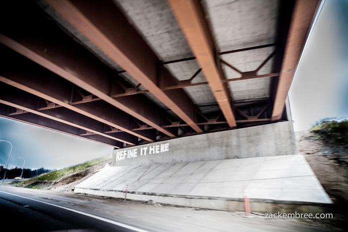 "Refine it here." Graffiti on highway leading into the tar sands. Photo by Zack Embree