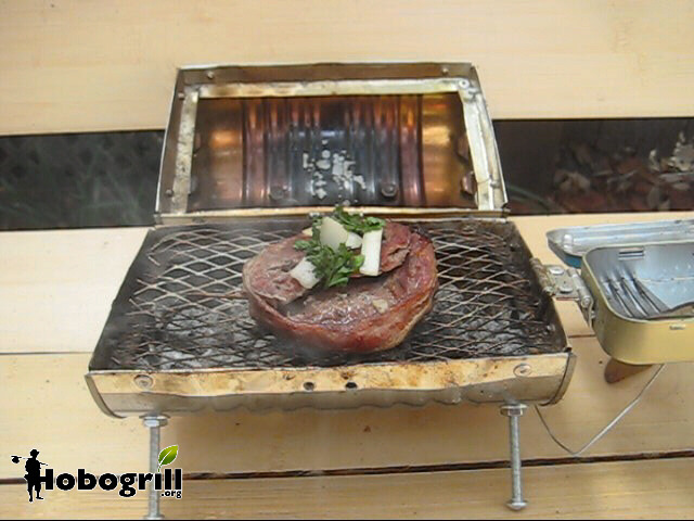 Cooking on a park bench, a bacon wrapped filet mignon topped with onion