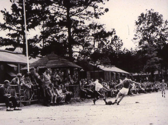 German POWs play soccer at an American prison camp.