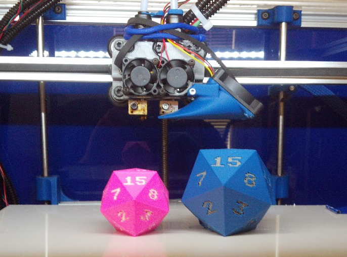 Left: pink PLA with white PLA numbers; Right: blue ABS with grey ABS numbers (d20 by PuppyKhan, thing:28681)