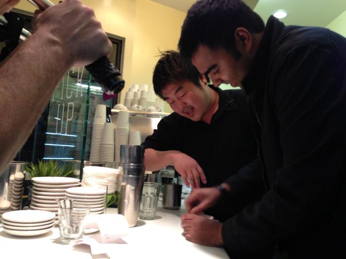 Rock being taught how to stir a latte by Tommy.