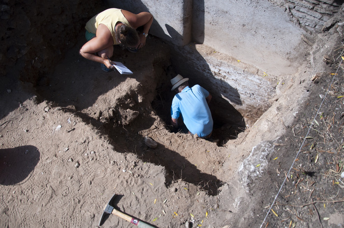Inspecting the foundation of East Terminal Wall. This photograph illustrates the difficulty of excavation in this area which had so much overlaying fill unable to be removed in the 2013 season.