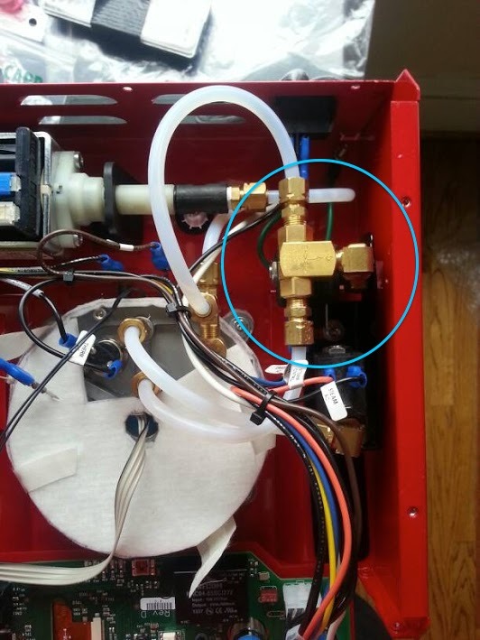 Water path assembly with new shuttle valve circled.