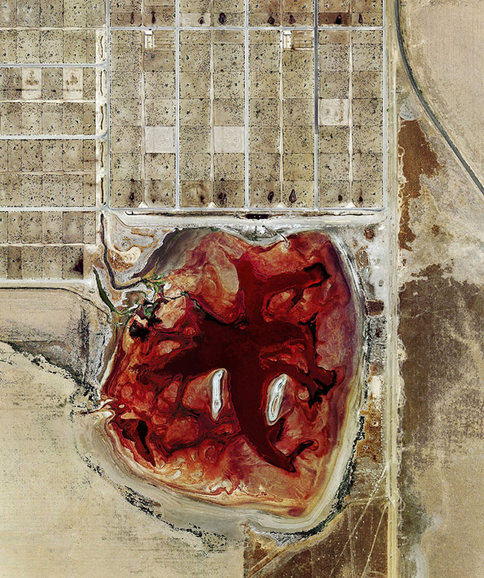 Photographer Mishka Henner documented factory farm pollution—like this waste lagoon at a Texas feedlot—by satellite. What else could drone photography uncover?