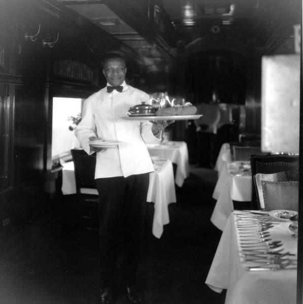 Dining Car waiter brings out another famous "GREAT BIG BAKED POTATO"