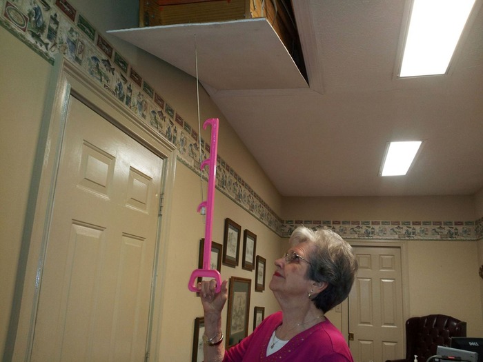 Getting Nanny to test out the Handy Reach. Testing required 19 lbs of downward force to pull open the stairs. She was not able to pull down the string without the Handy Reach!!